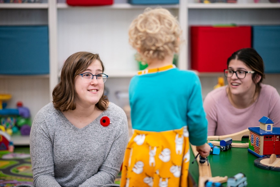 Early Childhood Educators interact with a child in an early education setting